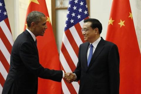 U.S. President Barack Obama (L) shakes hands with Chinese Premier Li Keqiang during their meeting in the Great Hall of the People in Beijing, November 12, 2014. PHOTO BY REUTERS/Kevin Lamarque