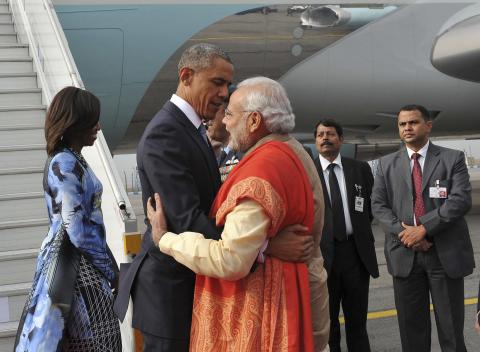 India's Prime Minister Narendra Modi (C) hugs U.S. President Barack Obama as first lady Michelle Obama (L) looks on upon their arrival at Air Force Station Palam in New Delhi, January 25, 2015. PHOTO BY REUTERS/India's Press Information Bureau/Handout via Reuters