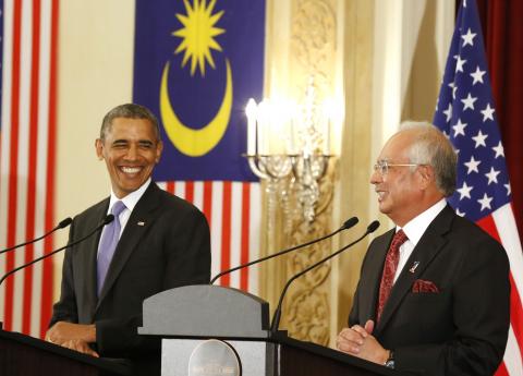 U.S. President Barack Obama and Malaysian Prime Minister Najib Razak both smile as they participate in a joint news conference at the Perdana Putra Building in Putrajaya, Malaysia