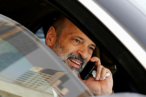 Jordan's designated new prime minister Omar al-Razzaz speaks on the phone after leaving the Parliament building in Amman, Jordan, June 7, 2018. PHOTO BY REUTERS/Muhammad Hamed