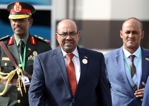 Sudanese President Omar al-Bashir walks with officials as he leaves an African Union summit in Nouakchott, Mauritania, July 2, 2018. PHOTO BY REUTERS/Ludovic Marin/Pool