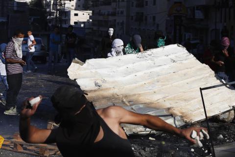 Palestinian protesters clash with Israeli security forces following Friday prayers at Shuafat refugee camp in the West Bank