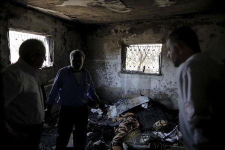 Palestinians inspect a house which was set on fire in a suspected attack by Jewish extremists in Duma village near the West Bank city of Nablus, July 31, 2015. PHOTO BY REUTERS/Ammar Awad