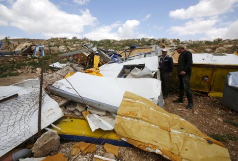 Palestinians look at the remains of a school project that was funded by the European Commission Humanitarian Aid and Civil Protection (ECHO) and was demolished by Israeli forces, in Khirbet Tana near the West Bank city of Nablus, March 29, 2016. PHOTO BY REUTERS/Abed Omar Qusini