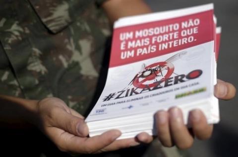 A Brazilian Army soldier shows a pamphlet which will be distributed in the city, after a ceremony to mark the graduation from training on how to combat the Aedes aegypti mosquito in Rio de Janeiro, Brazil, February 12, 2016. PHOTO BY REUTERS/Ricardo Moraes
