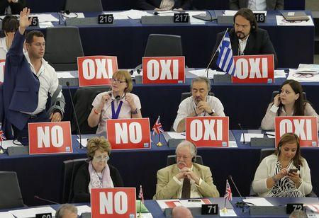 Members of the European Parliament with posters with the word "No" (Oxi) attend a debate on Greece at the European Parliament in Strasbourg, France, July 8, 2015. PHOTO BY REUTERS/Vincent Kessler