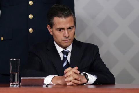 Mexico's President Enrique Pena Nieto sits during a meeting with lawyers in Mexico City, November 21, 2014. PHOTO BY REUTERS/Tomas Bravo