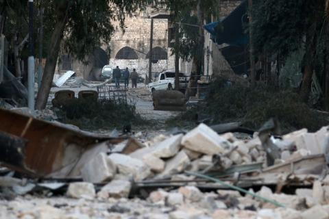 People walk near rubble of damaged buildings, in the rebel-held besieged area of Aleppo, Syria, November 19, 2016. PHOTO BY REUTERS/Abdalrhman Ismail