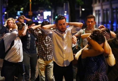 People leave the area with their hands up after an incident near London Bridge in London, Britain, June 4, 2017. PHOTO BY REUTERS/Neil Hall