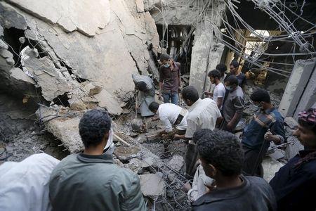 People search for survivors under the rubble of the collapsed house of Yemen's late prime minister Faraj Bin Ghanim after it was hit by a Saudi-led air strike in Sanaa, July 2, 2015. PHOTO BY REUTERS/Khaled Abdullah