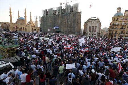 People carry Lebanese national flags and banners as they take part in an anti-government protest at Martyrs' Square in downtown Beirut, Lebanon, August 29, 2015. PHOTO BY REUTERS/Jamal Saidi