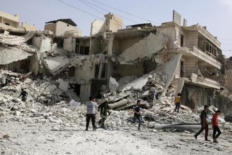 People inspect a damaged site after airstrikes on the rebel held al-Qaterji neighbourhood of Aleppo, Syria, September 21, 2016. PHOTO BY REUTERS/Abdalrhman Ismail