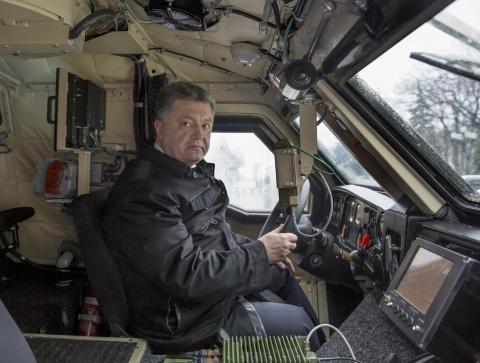 Ukraine's President Petro Poroshenko sits in the driver's seat of an armoured vehicle in Kiev, January 30, 2015, in this handout courtesy of the Ukrainian Presidential Press Service. PHOTO BY REUTERS/Mykola Lazarenko