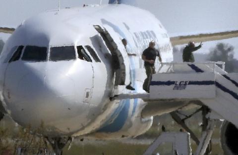 Unidentified people leave the hijacked Egyptair Airbus A320 at Larnaca Airport in Larnaca, Cyprus, March 29, 2016. PHOTO BY REUTERS/Yiannis Kourtoglou
