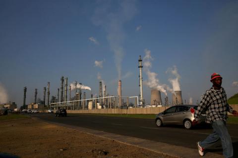 A man walks past South African petrochemical company Sasol's synthetic fuel plant in Secunda, north of Johannesburg, March 1, 2016. PHOTO BY REUTERS/Siphiwe Sibeko