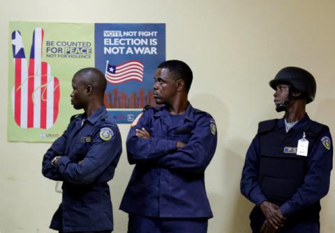 Police officers look on as they stand guard at National Election Commission headquarters in Monrovia, Liberia, October 11, 2017. PHOTO BY REUTERS/Thierry Gouegnon