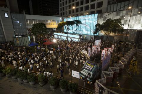 Police stand guard at the main road at Central during a march by protesters to demand universal suffrage in Hong Kong