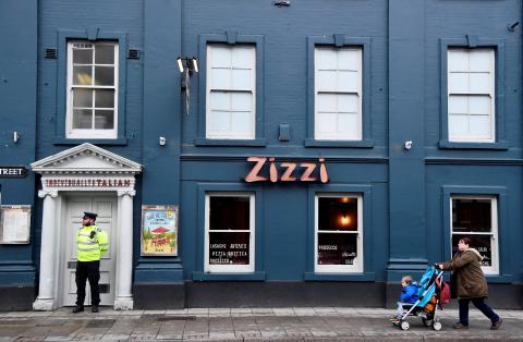A police officer stands outside a restaurant which was closed after former Russian inteligence officer Sergei Skripal, and a woman were found unconscious on a bench nearby after they had been exposed to an unknown substance, in Salisbury, Britain, March 6, 2018. PHOTO BY REUTERS/Toby Melville