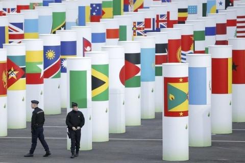 French police officers patrol in front of the entrance at the venue for the World Climate Change Conference 2015 (COP21) at Le Bourget, near Paris, France, November 29, 2015. PHOTO BY REUTERS/Stephane Mahe