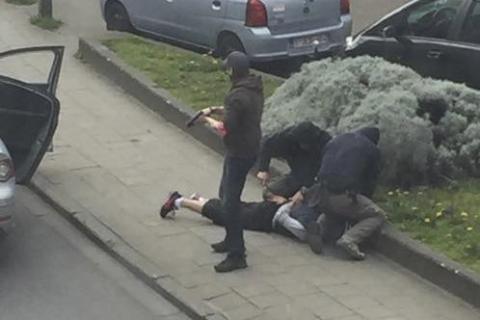 Police officers detain a suspect during a raid in which fugitive Mohamed Abrini was arrested in Anderlecht, near Brussels, Belgium, April 8, 2016 in this still image taken from video. PHOTO BY REUTERS/Sebastien Dana-Kamran via Reuters TV