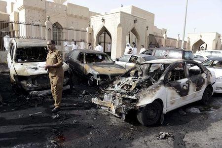 A policeman carries out an inspection after a car exploded near the Shi'ite al-Anoud mosque mosque in Saudi Arabia's Dammam, May 29, 2015. PHOTO BY REUTERS/Faisal Al Nasser