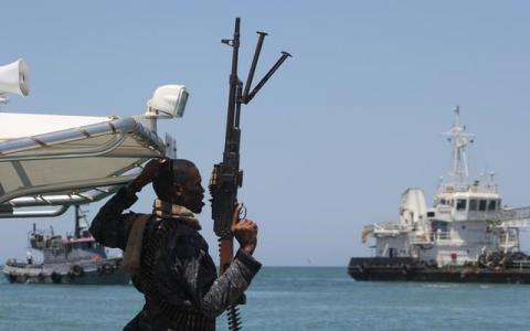 A maritime policeman on a tag-boat guards oil tanker Aris-13, which was released by pirates, as it sails to dock on the shores of the Gulf of Aden in the city of Bosasso, northern Somalia's semi-autonomous region of Puntland, March 19, 2017. PHOTO BY REUTERS/Abdiqani Hassan