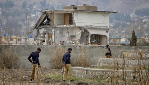 Policemen stand guard near the partially demolished compound where al Qaeda leader Osama bin Laden was killed by U.S. special forces last May, in Abbottabad, February 26, 2012. PHOTO BY REUTERS/Faisal Mahmood