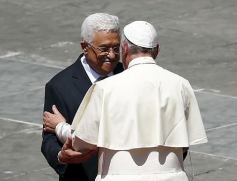 Pope Francis (R) embraces Palestinian President Mahmoud Abbas at the end of the ceremony for the canonisation of four nuns at Saint Peter's square in the Vatican City, May 17, 2015. PHOTO BY REUTERS/Tony Gentile