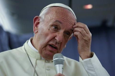Pope Francis gestures during a news conference on board the plane during his flight back from a trip to Chile and Peru, January 22, 2018. PHOTO BY REUTERS/Alessandro Bianchi