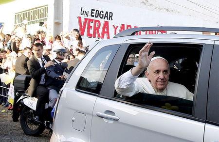 Pope Francis waves as he arrives to visit the Banado Norte neighborhood in Asuncion, Paraguay, July 12, 2015. PHOTO BY REUTERS/Alessandro Bianchi