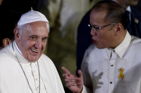 Pope Francis smiles as Philippines' President Benigno Aquino talks to him upon his arrival at Villamor Air Base for a state and pastoral visit, in Manila, January 15, 2015. PHOTO BY REUTERS/Erik De Castro
