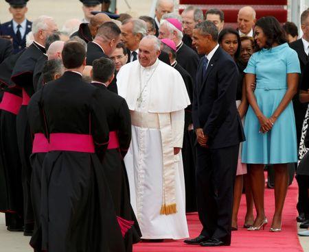 U.S. President Barack Obama (R) welcomes Pope Francis to the United States as the Pontiff shakes hands with dignitaries upon his arrival at Joint Base Andrews outside Washington September 22, 2015. REUTERS/Kevin Lamarque