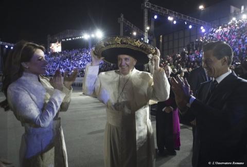 Pope Francis (C) wears a sombrero hat as he meets Mexico's President Enrique Pena Nieto (R) and first lady Angelica Rivera after his arrival in Mexico City, February 12, 2016. PHOTO BY REUTERS/Osservatore Romano