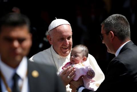 Pope Francis holds a baby after celebrating a Mass at San Cristobal de las Casas, Mexico, February 15, 2016. PHOTO BY REUTERS/Carlos Garcia Rawlins
