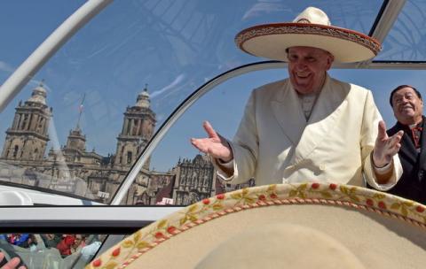 Pope Francis gestures while wearing a Mariachi hat given to him by someone in the crowd on Zocalo Square in Mexico City. PHOTO BY REUTERS/Mexico Presidency