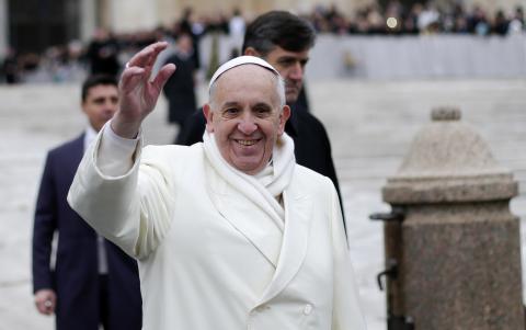 Pope Francis waves as he conducts his weekly general audience at St. Peter's Square at the Vatican