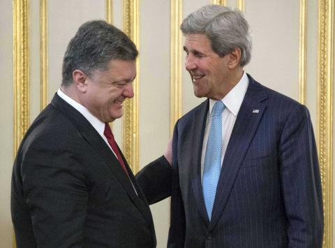 U.S. Secretary of State John Kerry (R) smiles with Ukraine's President Petro Poroshenko (L) during a bilateral meeting in Kiev, February 5, 2015. PHOTO BY REUTERS/Jim Watson