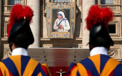 Swiss Guards stand in front of a tapestry depicting Mother Teresa of Calcutta before a mass, celebrated by Pope Francis, for her canonisation in Saint Peter's Square at the Vatican, September 4, 2016. PHOTO BY REUTERS/Stefano Rellandini