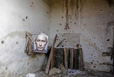 A poster of Russian President Vladimir Putin with the words Republika Srpska (Serb Republic) printed on it is seen inside the main residence of an abandoned agricultural cooperative in Kravica, Bosnia and Herzegovina, July 1, 2015. PHOTO BY REUTERS/Dado Ruvic