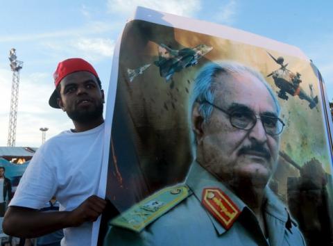 A man holds a picture of General Khalifa Haftar during a demonstration in support of the Libyan army under the leadership of General Khalifa in Benghazi, Libya, November 6, 2015. PHOTO BY REUTERS/Esam Omran Al-Fetori