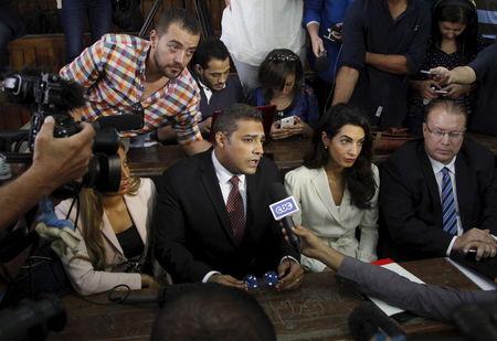 Al Jazeera television journalists Mohamed Fahmy, C, and Baher Mohamed, L, talk to the media with lawyer Amal Clooney, 2nd R, Troy Lulashnyk, R, Canadian Ambassador to Egypt, before hearing the verdict at a court in Cairo, Egypt, August 29, 2015. PHOTO BY REUTERS/Asmaa Waguih