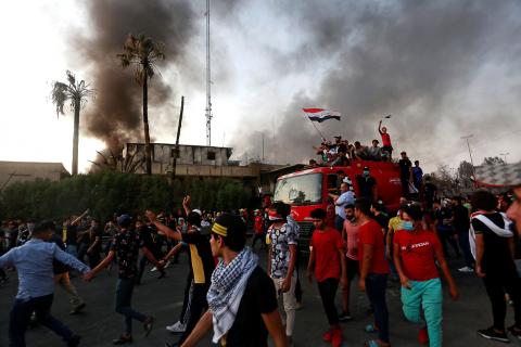 Iraqi protesters stand on a fire truck during an anti-government protest near the burnt building of the government office in Basra, Iraq, September 7, 2018. PHOTO BY REUTERS/Alaa al-Marjani