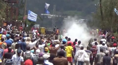 A still image taken from a video shot on October 1, 2017, shows protesters waving Ambazonian flags as they move forward towards barricades and police amid tear gas in the English-speaking city of Bamenda, Cameroon. PHOTO BY REUTERS/via Reuters TV