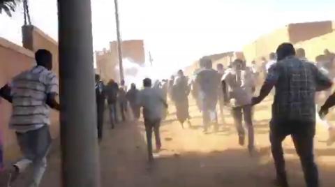 People run as tear gas canisters are thrown at them during an anti-government protest in Omdurman, Sudan January 9, 2018 in this still image taken from social media video. PHOTO BY REUTERS/Haitham Seo