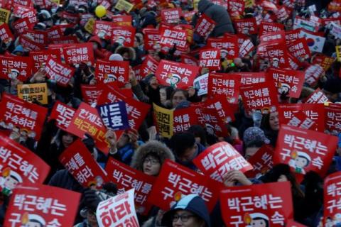 People attend a protest demanding South Korean President Park Geun-hye's resignation in Seoul, South Korea, December 24, 2016. The signs read "Arrest Park Geun-hye". PHOTO BY REUTERS/Kim Hong-Ji