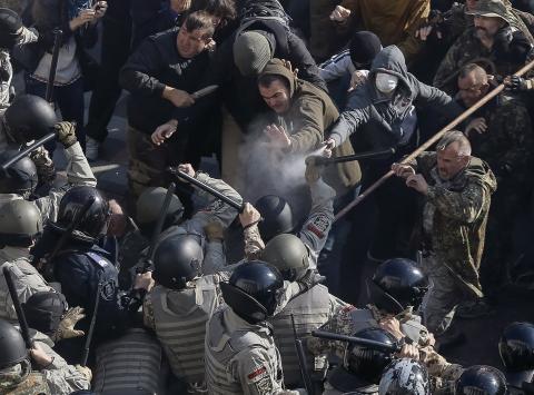 Radical protesters clash with law enforcement members on the Day of Ukrainian Cossacks during a rally near the parliament building in Kiev