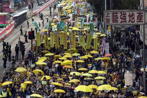 Thousands of pro-democracy protesters hold up yellow umbrellas, symbols of the Occupy Central movement, during a march in the streets to demand universal suffrage in Hong Kong, February 1,2015. PHOTO BY REUTERS/Tyrone Siu