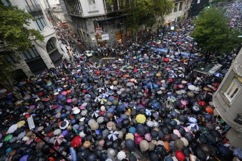 Protesters holding umbrellas to shield themselves from the rain take part in a silent march to honour late state investigator Alberto Nisman in Buenos Aires, February 18, 2015. PHOTO BY REUTERS/Enrique Marcarian