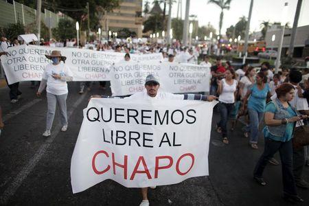 A protester holds a sign reading, "We want Chapo free" during a march in Culiacan, in this February 26, 2014 file photo. PHOTO BY REUTERS/Daniel Becerril