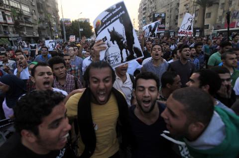 Demonstrators shout slogans against the government and Egypt's former army chief Abdel Fattah al-Sisi near El-Thadiya presidential palace in Cairo